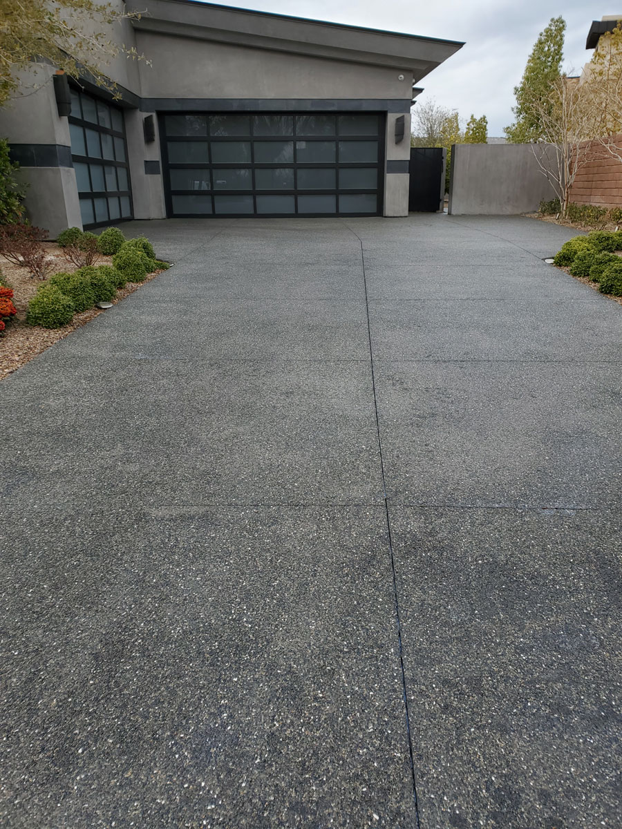 Clean dark aggregate concrete driveway