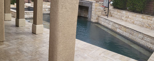 Travertine stone patio and pool deck area
